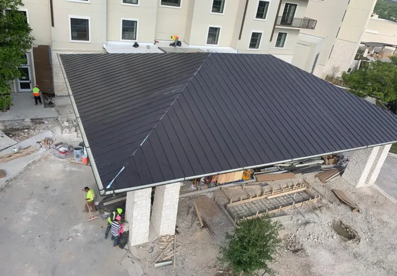 Metal roofing installation team working on a commercial building in Palm Beach Gardens