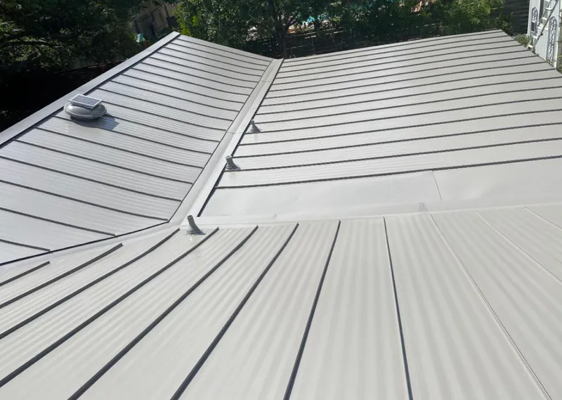 Solar attic fan installed on a metal roof for Roof Ventilation in Palm Beach Gardens